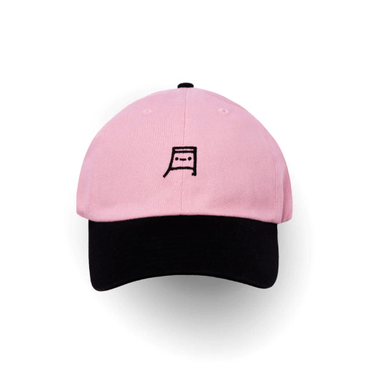 A pink trucker hat with a black bill and a cute Japanese letter-styled character design.