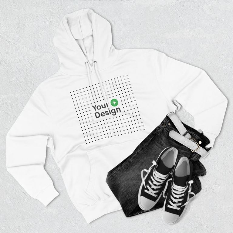 White pullover hoodie with the “Add your design” sign on the front, surrounded by jeans and sneakers.