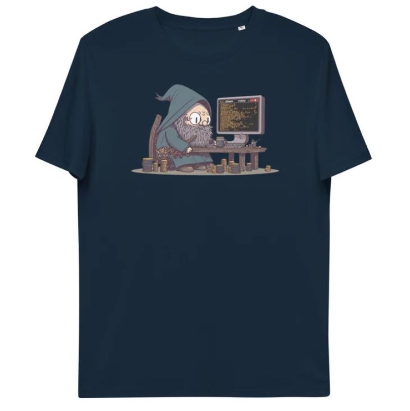 A dark blue t-shirt depicting a cartoon wizard dressed in a robe sitting by an old desk that's surrounded by stacks of coins, with a flat-screen monitor showing some HTML code.