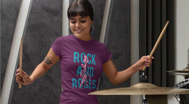 An image of a woman playing drums wearing custom band merch.