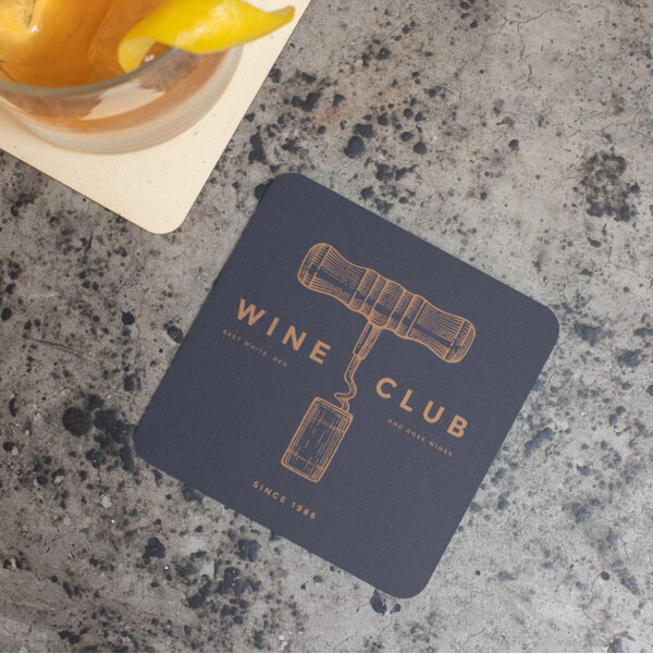 Square coaster with a design of a wine bottle opener and the text “Wine Club. Best white, red, and rosé wines since 1986.”