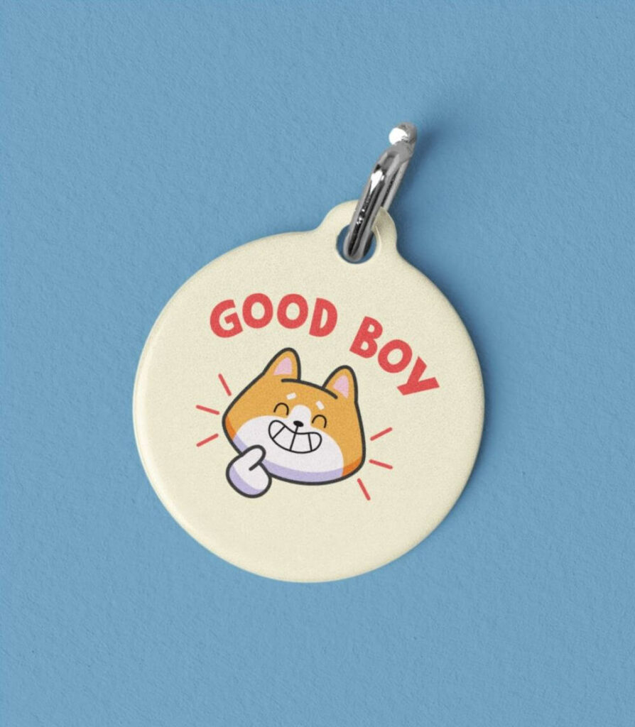 Blue background with a round pet tag featuring a cartoon cat illustration with the text "Good Boy" written above the cat image.
