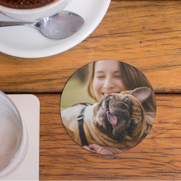 Round custom coaster with a photo print of a girl and her French bulldog.