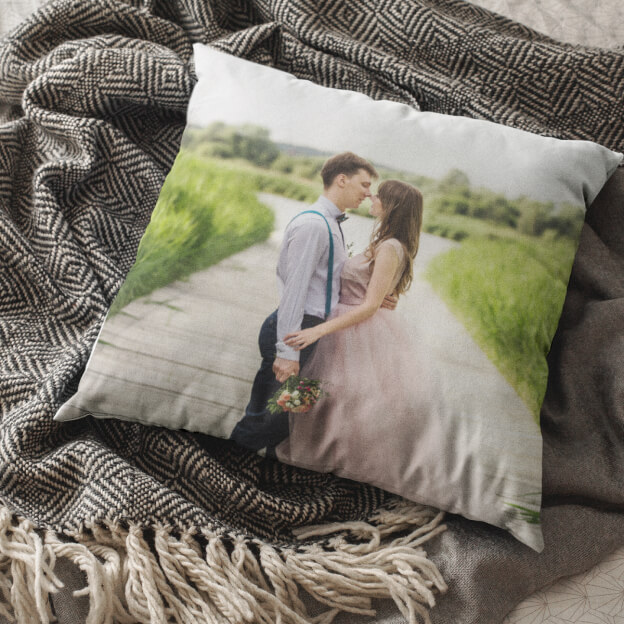 Top view of a pillow customized with a beautiful photo of a happy wedding couple.