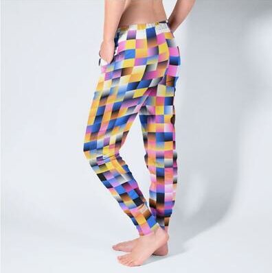A mockup image of a man wearing personalized sweatpants with an abstract print.
