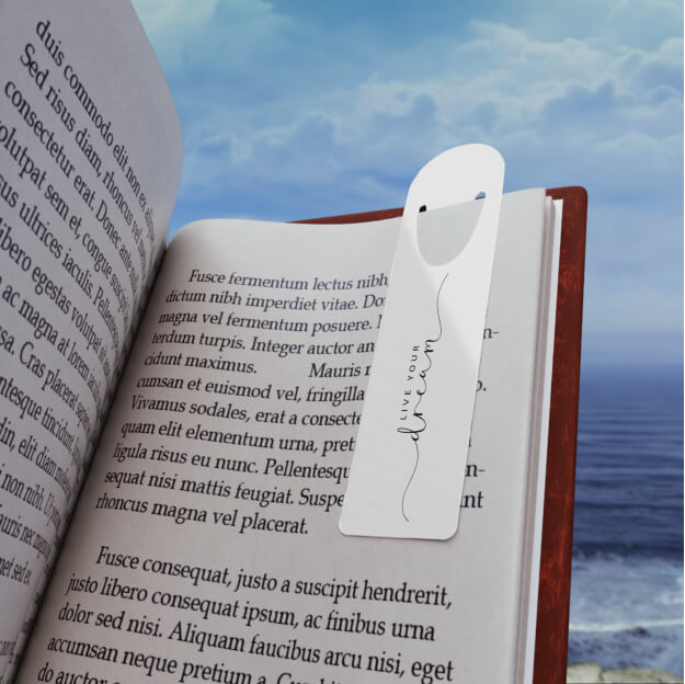 An open book with a custom bookmark that says “Live your dream”