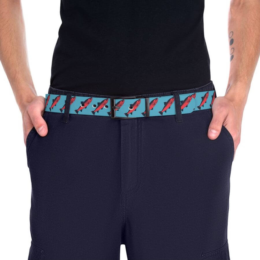 Man wearing a blue belt with a fish pattern.