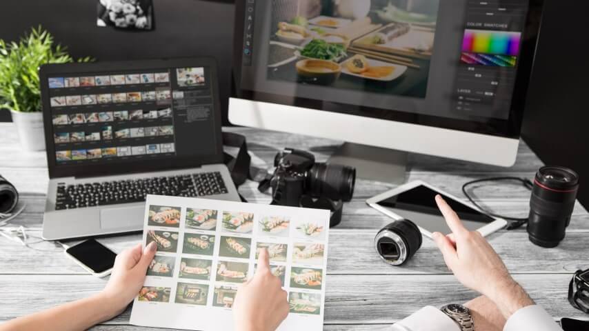 Two people picking and editing various photos of sushi sets.