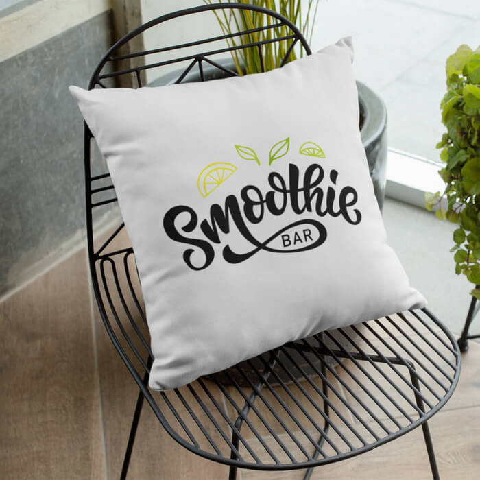 A mockup image of a personalized pillow with text on it placed on a chair.
