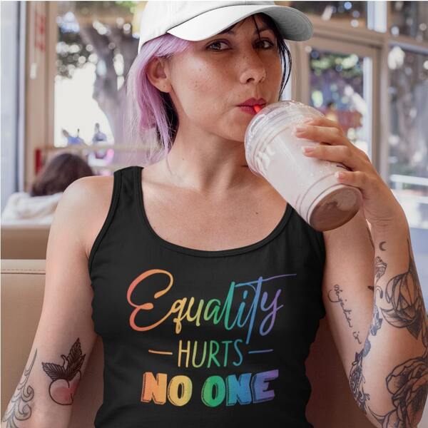 Lifestyle photo of a model drinking from a plastic cup, wearing a custom tank top with a rainbow gradient text “Equality Hurts No One” printed on the chest.