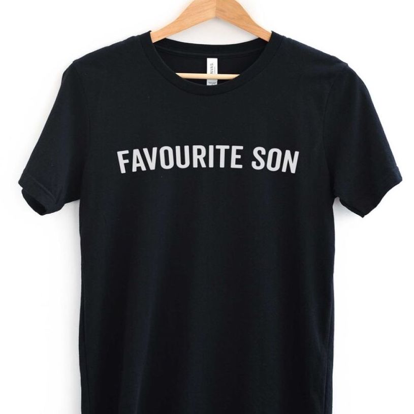 Black t-shirt with the words “Favourite son” in white lettering.