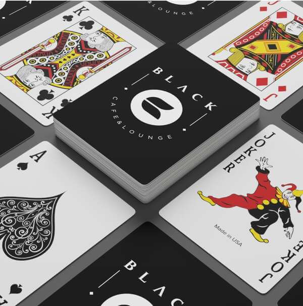 Spread-out deck of playing cards with a custom print of a logo for the “Black cafe & lounge”.