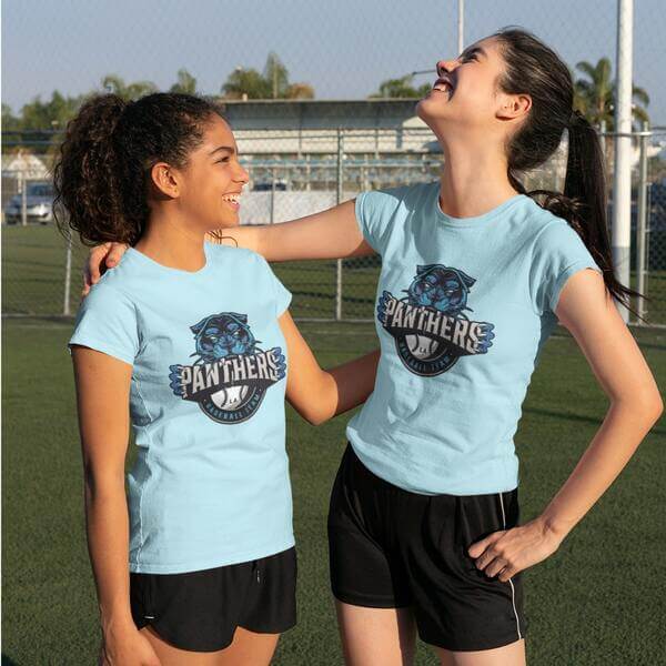 An image of two girls wearing blue colored custom team shirts with a logo in front.