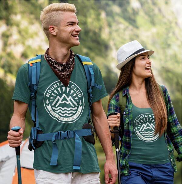 An image of a couple wearing custom team t-shirts while hiking.