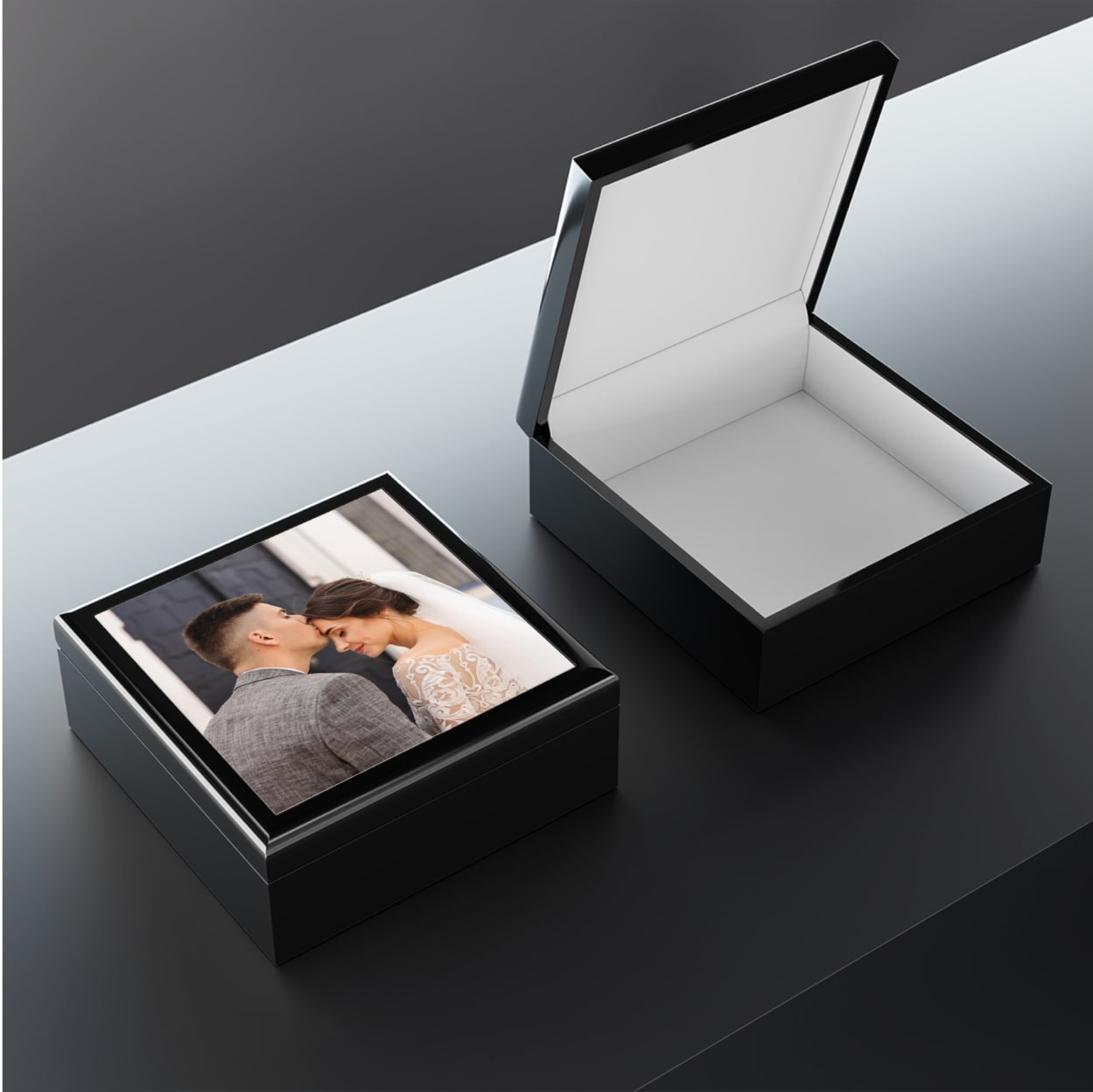 A mockup of a personalized jewelry box with a picture on top.