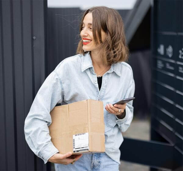 Photo of a woman receiving a print-on-demand package of a bulk order of playing cards.