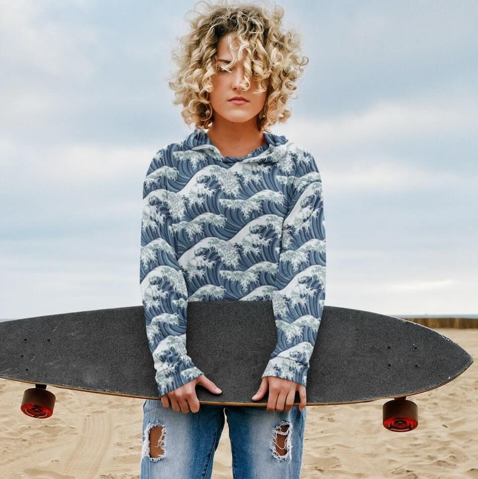 An image of a woman wearing a custom hoodie with a wave pattern.