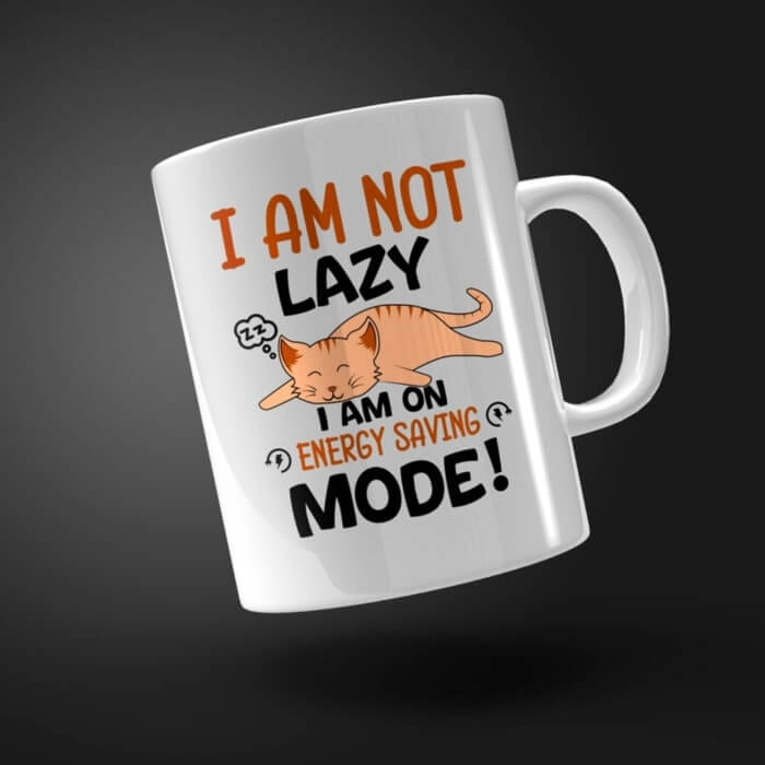 White mug with a graphic of a sleeping orange cat and the text “I am not lazy, I am on energy saving mode!”