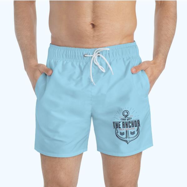 Mockup of light blue swim trunks with a logo on the left leg of an anchor and the text “The Anchor Sea Brand.”