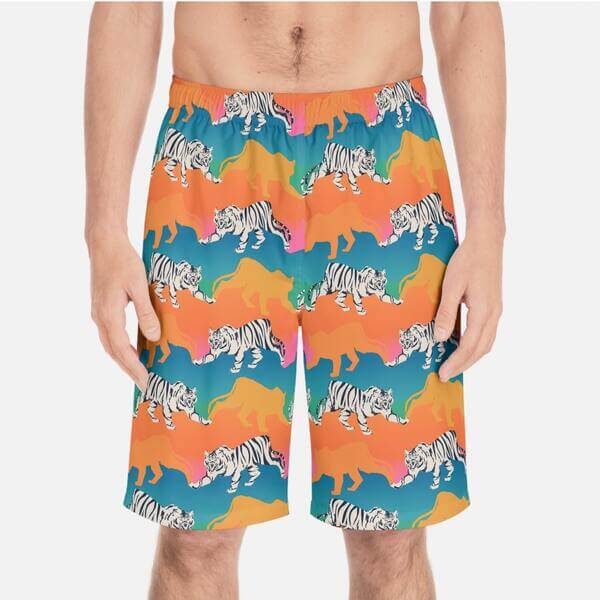 Mockup of personalized swim trunks with a pattern of white tigers surrounded by gradient yellow, orange, and blue tiger silhouettes.