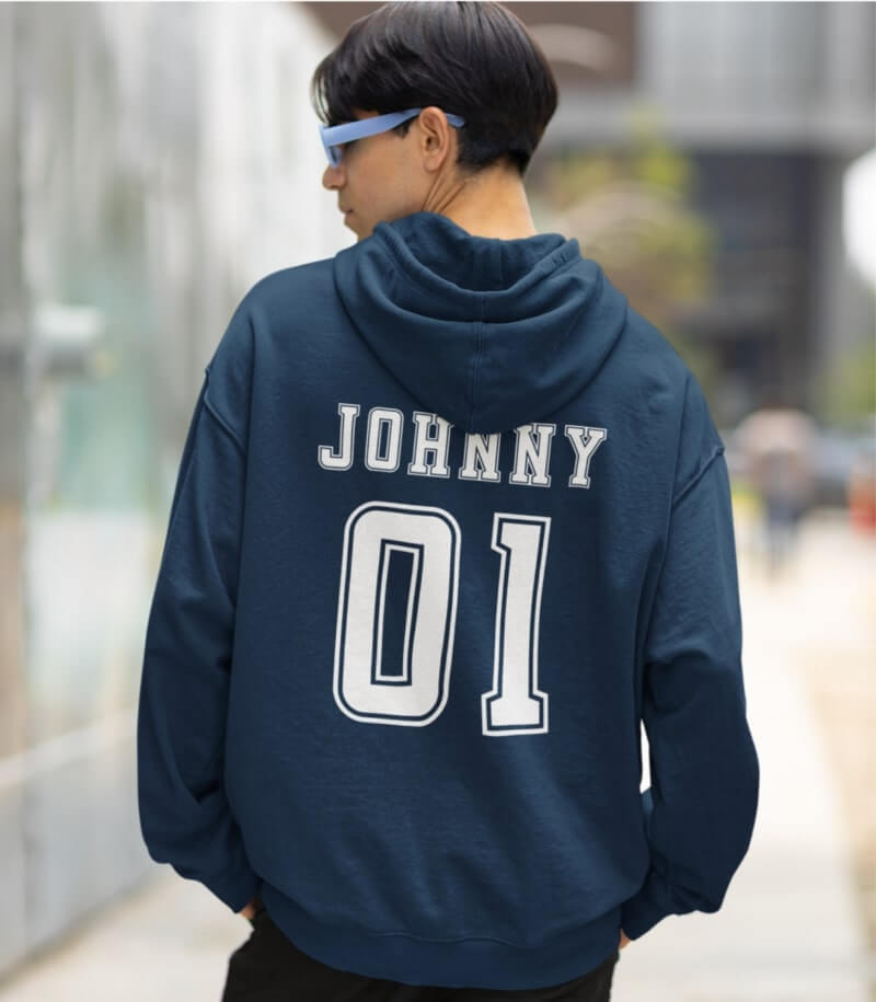 An image of a man wearing a custom hoodie in dark blue with a jersey-styled name and number on the back.