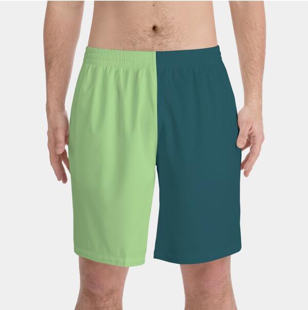 Mockup of personalized men's swim trunks with one half in light green, and the other half – in dark green color.