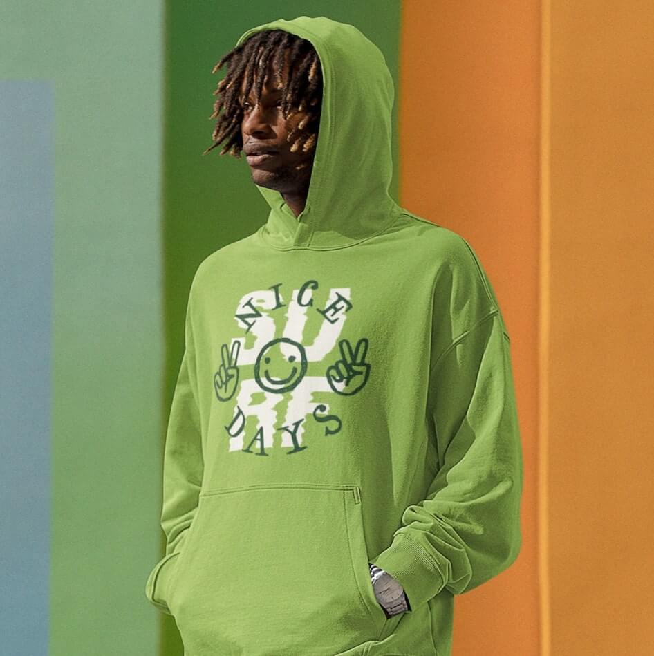 An image of a man wearing a green custom hoodie with different graphics and text.