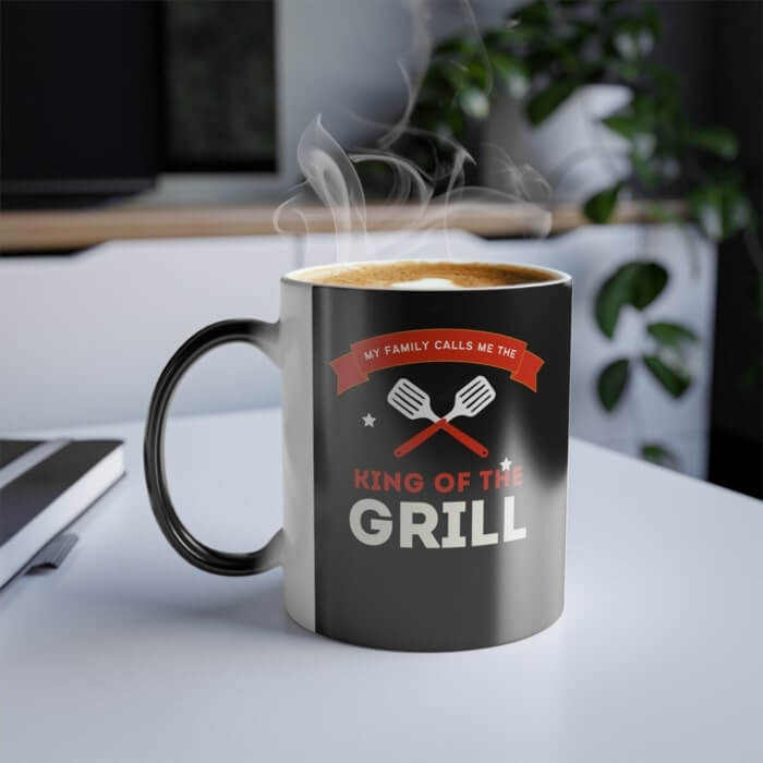 Color-changing coffee mug with a graphic of two crossed spatulas and the text “My family calls me the King of the grill.”