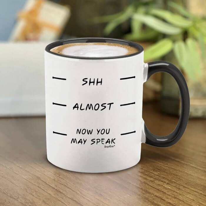 Black accent mug with measurement marks labelled “Shh,” “Almost,” “Now you may speak.”