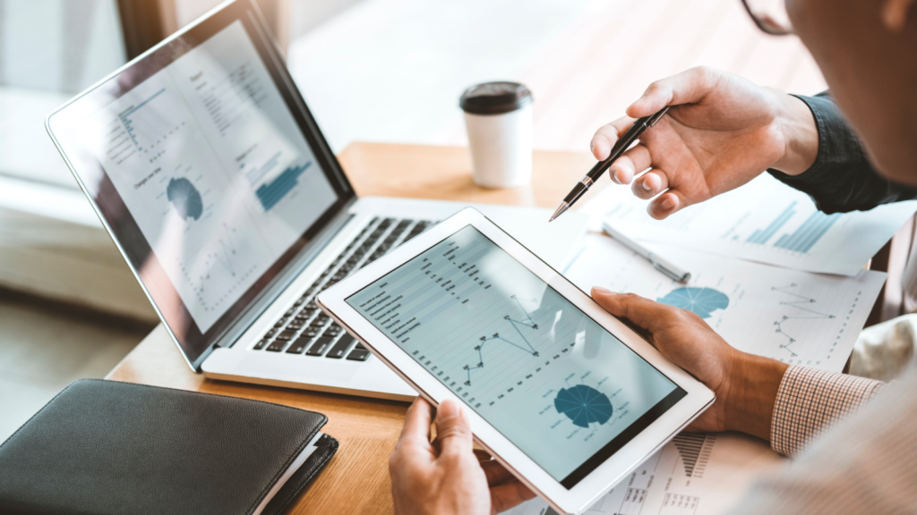 Businessman analyzing data on a tablet with a pen, focused on his work in a modern office setting.