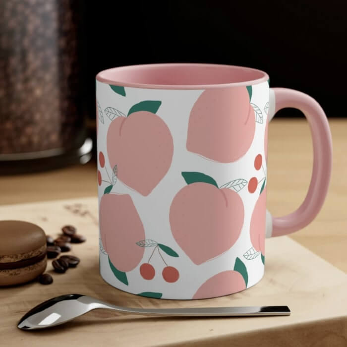 Pink accent mug with a pattern of peaches in the same shade of pink.