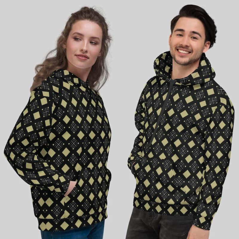 A man and a woman wearing matching hoodies with a geometric pattern of rhombuses in different shades of green and black.