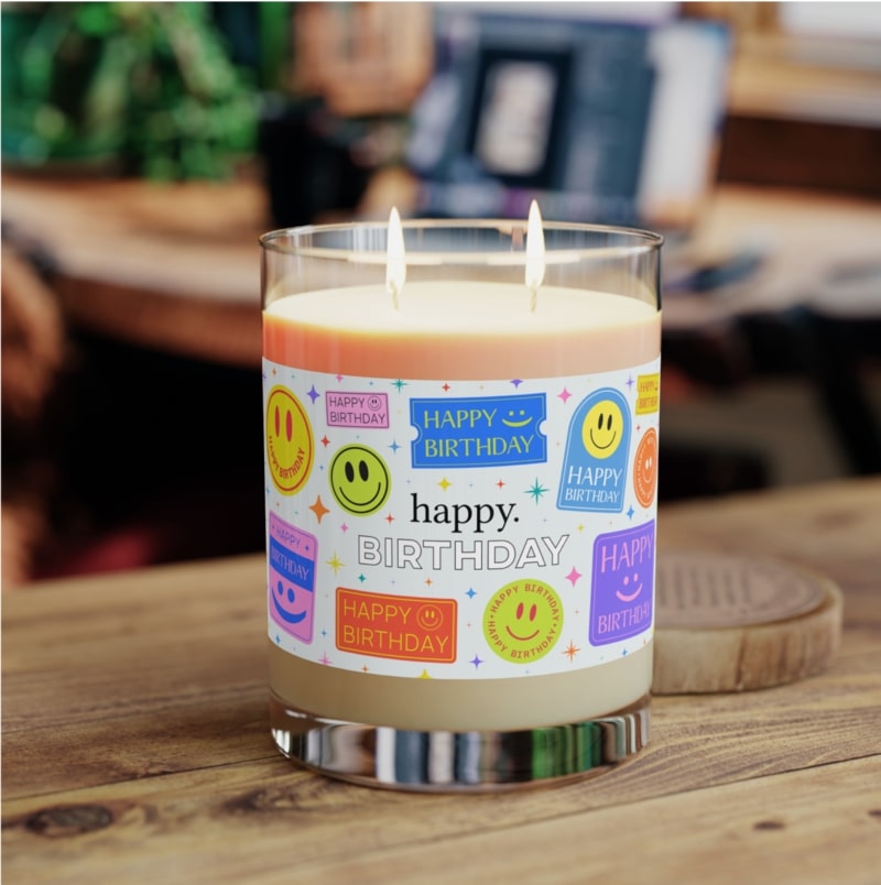 Customized double-wick candle with a "Happy birthday" design wrapped around it