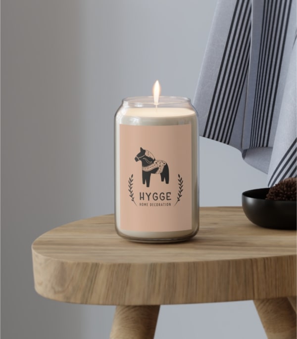 A scented candle with a custom design that has a name and an image of a horse on it