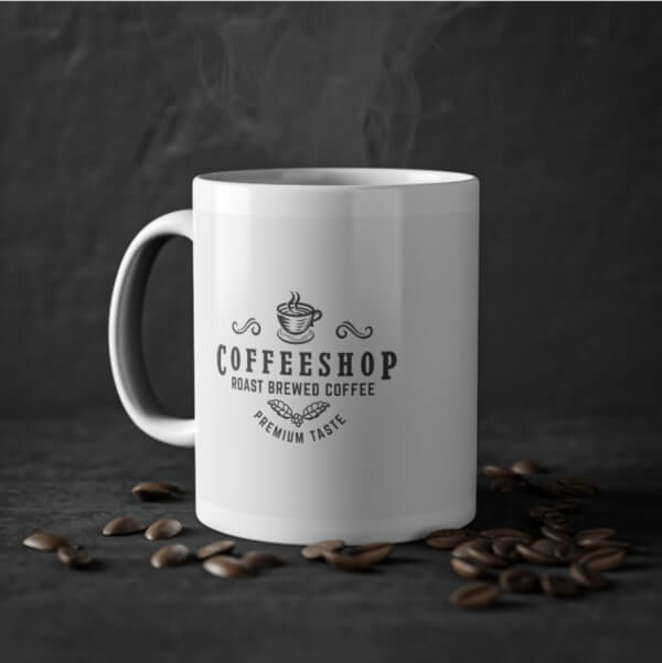 White mug with a logo of a tiny coffee cup and the text “Coffee Shop. Roast Brewed Coffee. Premium taste”
