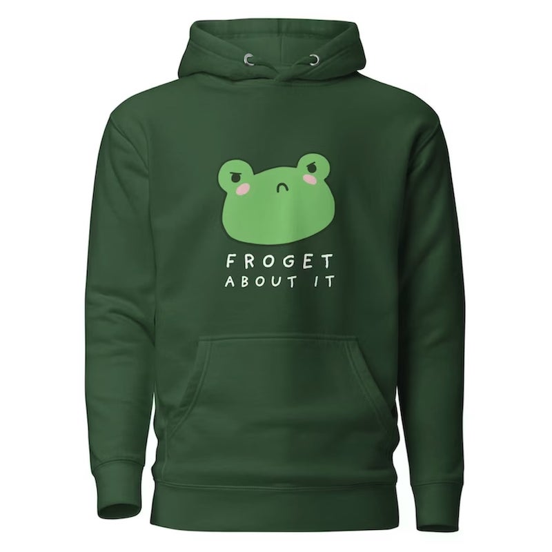 Forest green hoodie with a design of an angry cartoon frog and the text “Froget about it” underneath.