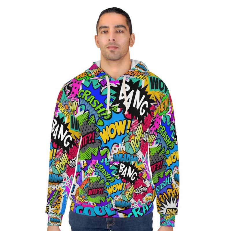 Man wearing an all-over-print hoodie with a design of various colorful comic captions.