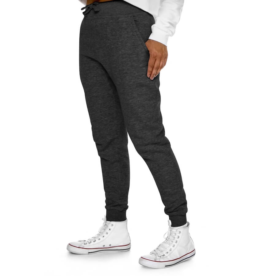 A woman wearing a white sweatshirt, white sneakers, and premium fleece joggers ready for your custom design