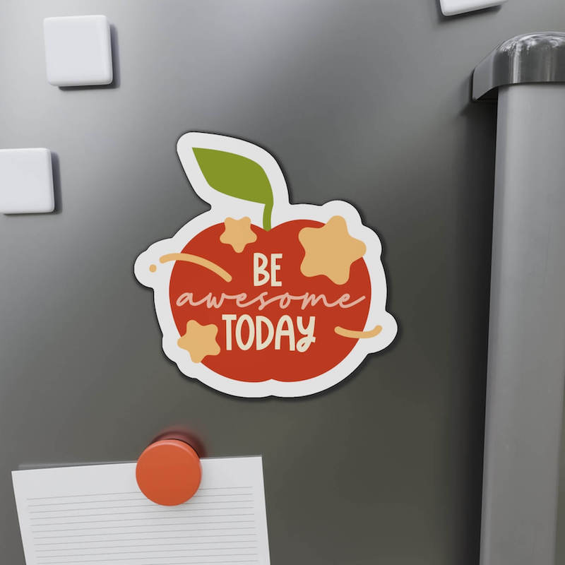 A custom magnet in the shape of an apple that says, "Be awesome today".