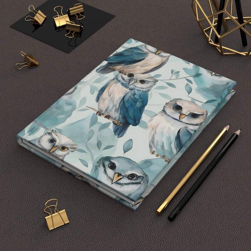 A hardcover journal with a custom design that has a blue owl pattern.