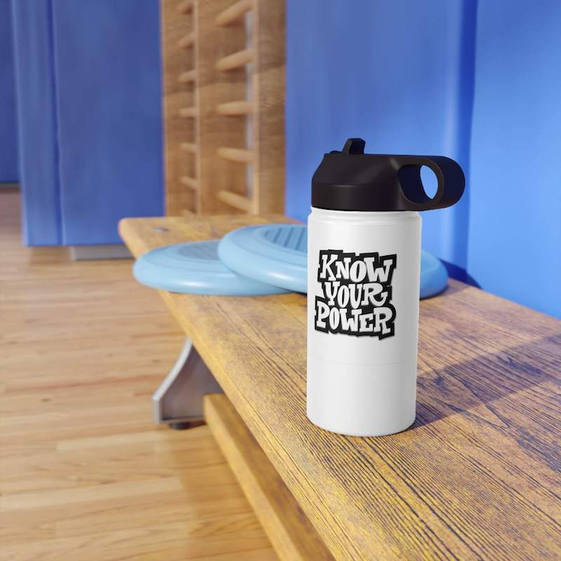 A gym setup with a stainless steel water bottle that says, "Know your power".