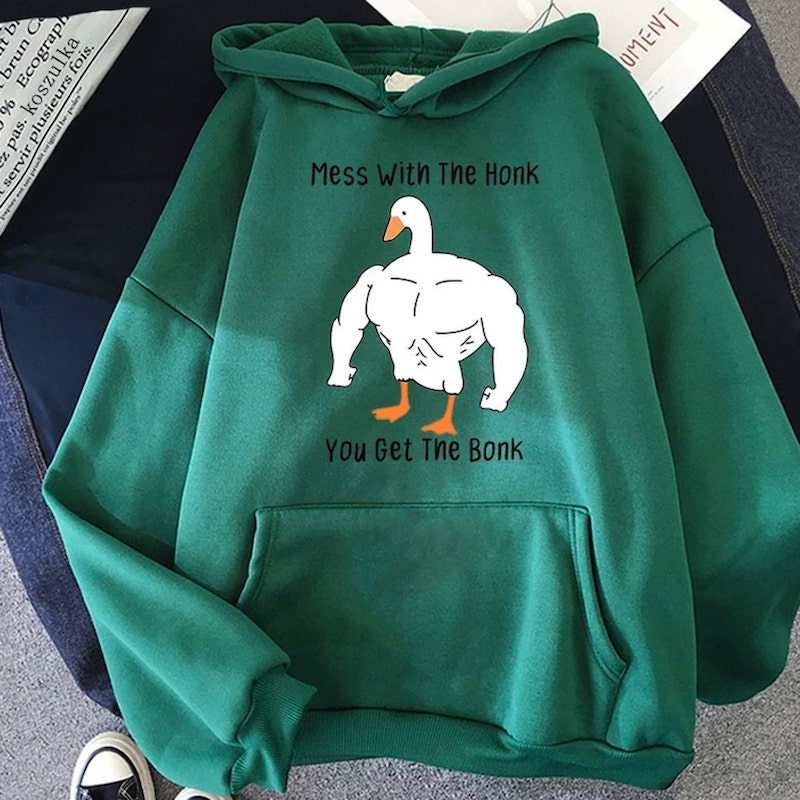 Dark green hoodie with an image of an extremely muscular anthropomorphic goose and the text “Mess with the honk, you get the bonk.”