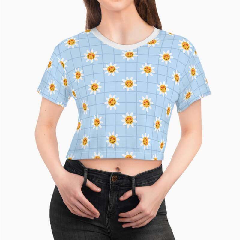 A mockup image of a woman wearing a custom crop tee with a blue and yellow flower print.