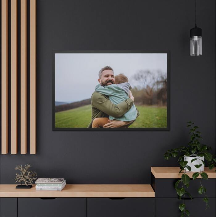 Framed poster with a family photo of a man holding his child.