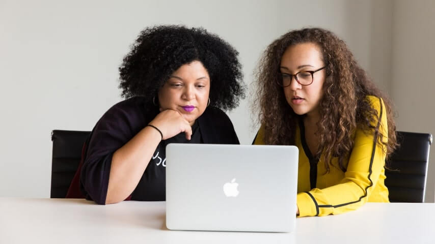 Set Up a Membership Website Two women working to learn how to monetize a website through setting up memberships.