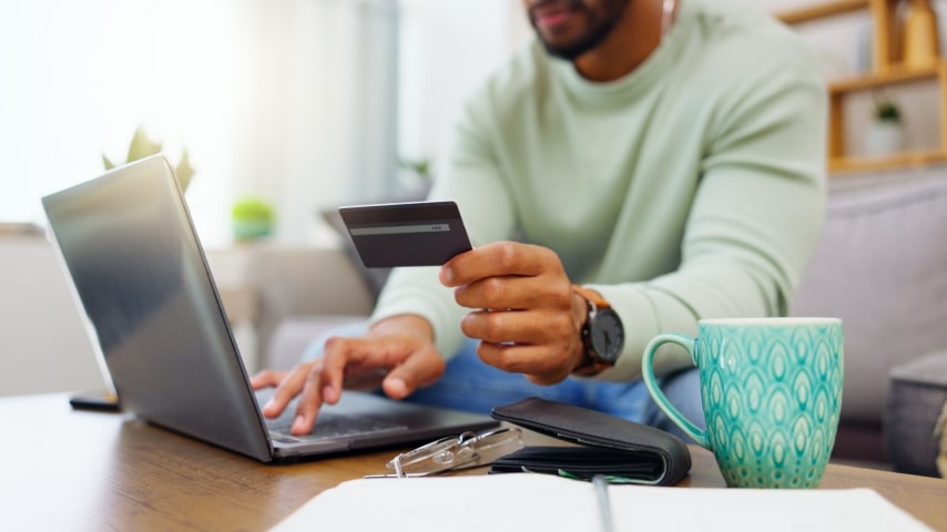 A guy holding his credit card, ready for the exciting Black Friday, Cyber Monday sale