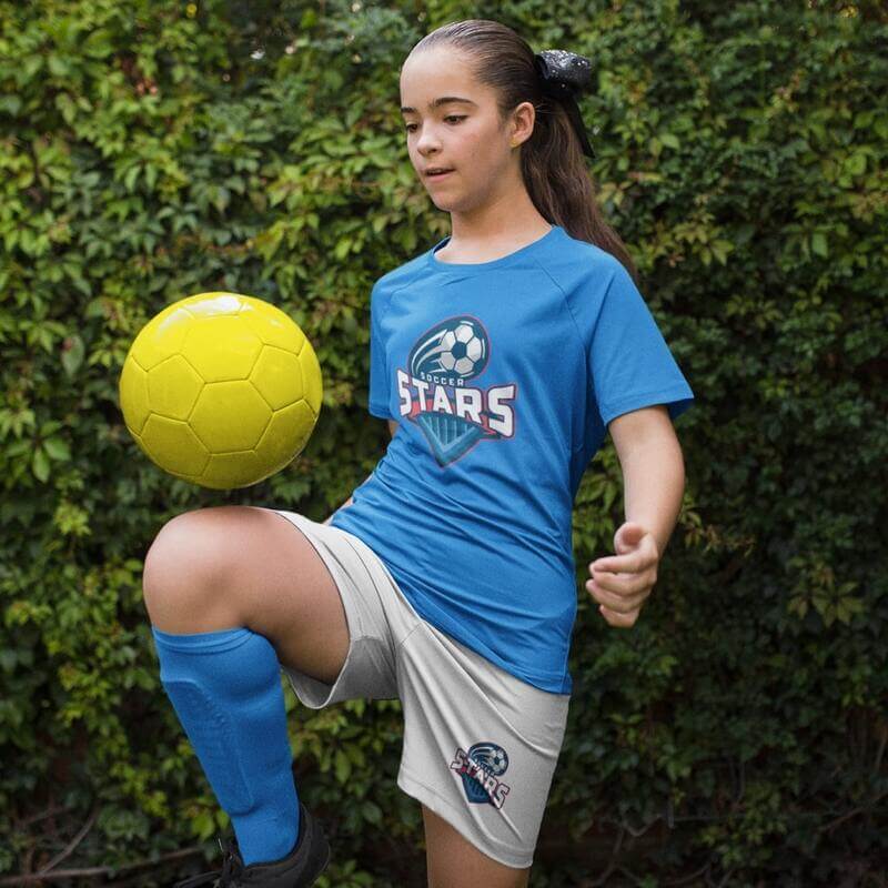 A girl wearing a custom school soccer uniform with a team logo.