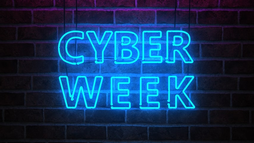 A brick wall with a neon sign that says Cyber Week