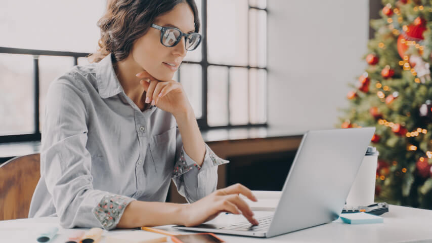 A woman working on her holiday marketing campaign to skyrocket her online sales.