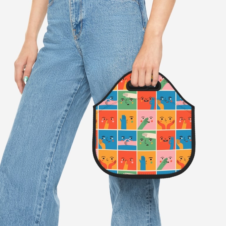 A mockup image of a woman holding a custom lunch bag with carrying handles.